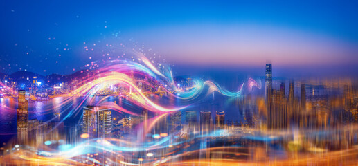 A cityscape with tall buildings illuminated at night, abstract glowing shapes, and a bright blue...