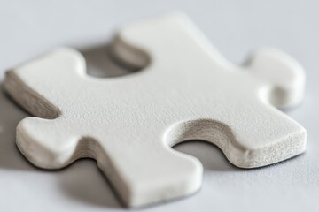A close up of a single white puzzle piece on a light blue background with space for text.