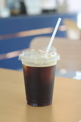 Black ice coffee or Americano coffee on wood table.