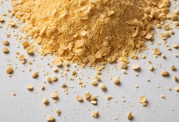 Nutritional yeast flakes, or dry inactive yeast falling background and texture.