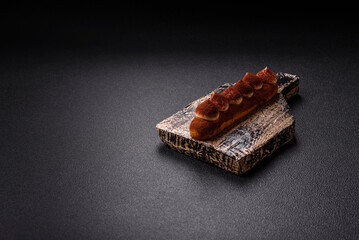 Sweet eclair with chocolate custard sprinkled with cocoa powder