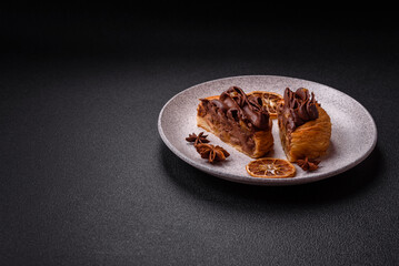 Sweet dessert danish covered with chocolate cream, with cream filling