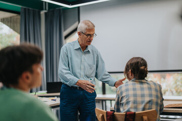 Fototapeta premium An elderly professor interacts with students in a classroom environment, fostering an atmosphere of learning and mentorship. The setting emphasizes education, communication, and academic engagement.