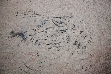 Graffiti on the concrete wall of a house. Aged wall background