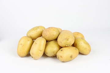 Group of raw unpeeled potatoes on a white background, horizontal image