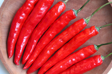 Some fresh big red chili, on wooden background, flat lay or top view