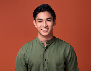 Obraz premium Portrait of Handsome Young Man Happily Smiling Against Colored Studio Background