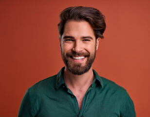 Fototapeta premium Portrait of Handsome Man Happily Smiling Against Colored Studio Background