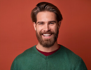 Fototapeta premium Portrait of Handsome Man Happily Smiling Against Colored Studio Background