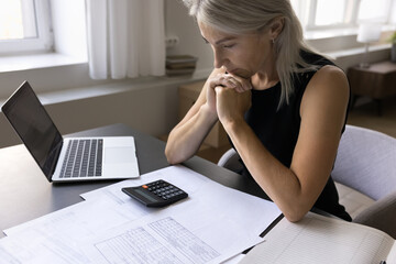 Serious old lady self employed businesswoman ponder on risky decision calculate possible income...
