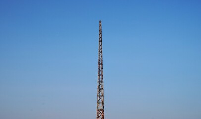 Obraz premium photo of a transmitter tower made of iron, towering high, with the sky in the background