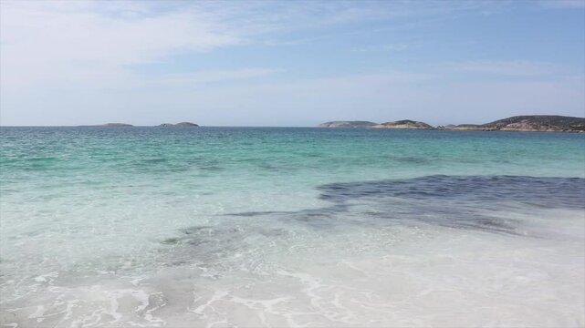 Clear blue waters of the sea with waves lapping onto the white sands. Paradise scene. Taken at Hellfire Bay, Cape Le Grand, Western Australia