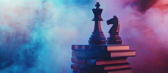 Business hierarchy Strategy idea featuring chess pieces Chess positioned on a stack of books with the king at the apex Dim foggy backdrop with colored light Copyspace