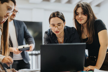 A diverse group of students engaged in a collaborative project with their professor, offering support and guidance. They are focused and actively participating in the learning process.