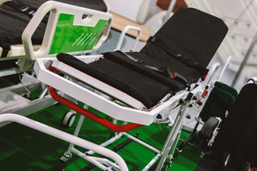 A medical wheelchair with mechanical height adjustment for transporting patients