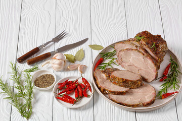 Roast Pork Neck sliced on a plate, top view