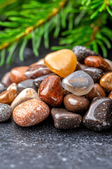 Obraz premium A mesmerizing collection of colorful pebbles and stones perfectly arranged against a natural backdrop