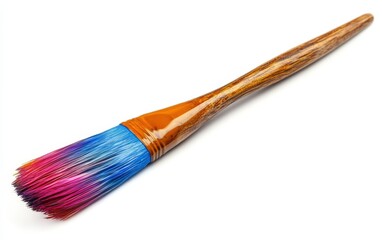 Fototapeta premium Single Paintbrush: A large paintbrush with colored bristles, isolated to show its wooden handle and detail on a white background 