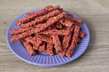 Delicious homemade cookies with seeds and vegetables on a purple plate ready for snacking