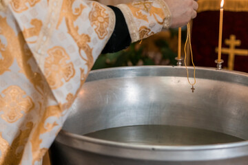 Ritual Baptism Ceremony with Golden Vestments and Cross