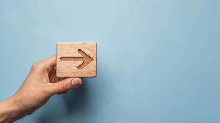 hand and a box with an arrow on the blue wall