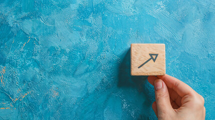 hand and a box with an arrow on the blue wall