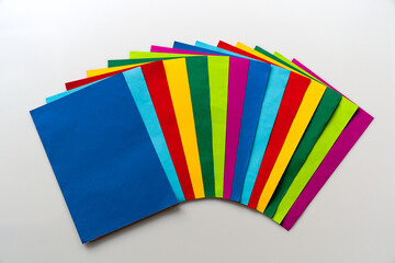Close-up top view of colorful fan shaped paper sheets against white background. Photo taken October...