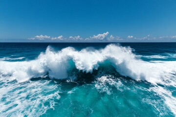 Fototapeta premium A stunning ocean wave crashing powerfully onto the shore with a bright blue sky above, embodying the beauty and force of nature in a serene, vast landscape.