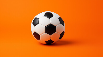 Naklejka premium soccer ball isolated on orange background