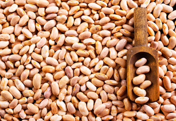 Beans and wooden spoon on a table, copy spase