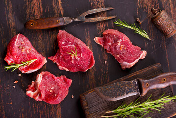 raw beaf on a dark wooden table.