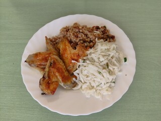 Baked chicken wings with buckwheat and vegetables