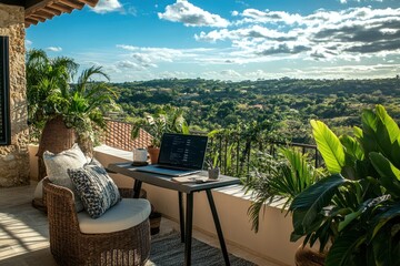 Fototapeta premium A laptop sits on a table on a patio overlooking a green valley.