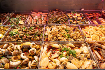 Squid and sea snails and crabs and shrimp and other seafoods at a street stall