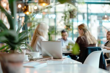 People engage in conversation at a cafe, surrounded by plants and cozy decor, creating a warm and inviting atmosphere with soft ambient lighting.