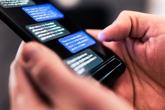 Text message with phone. Sms texting chat. Mobile scam or fraud. Communication messenger app. Macro closeup of smartphone screen. Night conversation with friend. Sending or reading. Instant messaging.