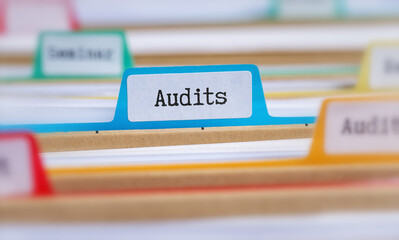 File folders with a tab labeled Audits