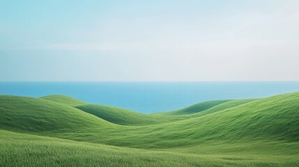Fototapeta premium A serene landscape showcasing rolling green hills meeting the calm ocean under a clear blue sky, perfect for evoking peace and natures beauty