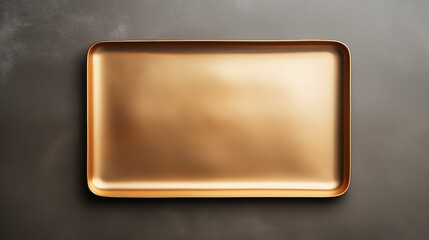 Rectangular copper gold plate on brown table. Gold tray, top view
