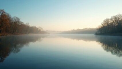 Fototapeta premium Tranquil lake at dawn reflecting sky and trees