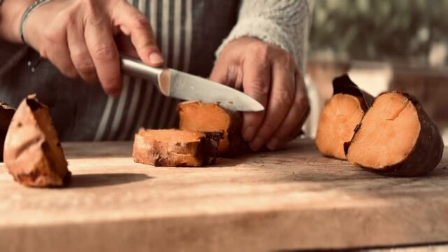 Cook chopping boiled sweet potato.
