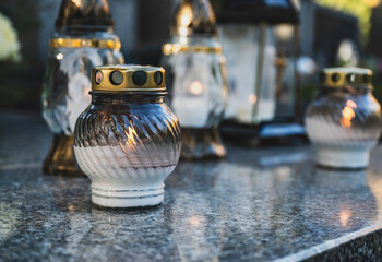 Lit Candle on a Grave Surrounded by Autumn Leaves During All Saints' Day in Poland