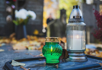 Lit Candle on a Grave Surrounded by Autumn Leaves During All Saints' Day in Poland