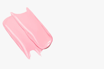 Composition of pink smears on a light background. Skincare cream or lipstick, beauty textures.