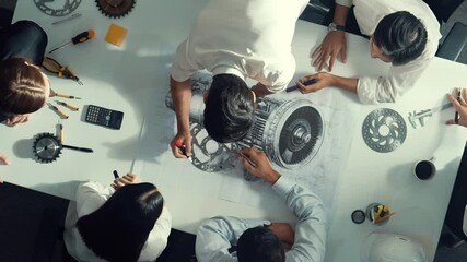 Top view of skilled engineer writing and measure turbine engine by using pencil. Aerial view of technician or designer workinjg together to brainstorm and design electronic generator. Alimentation.