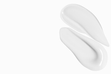 Composition of white cream smears on a light background. Skincare product, smooth textures.