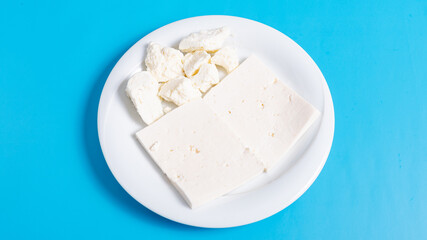 Sliced white cheese on plate 