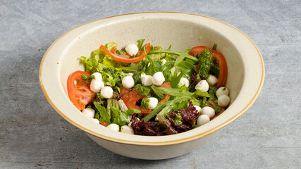 Greek salad bowl isolated on grey
