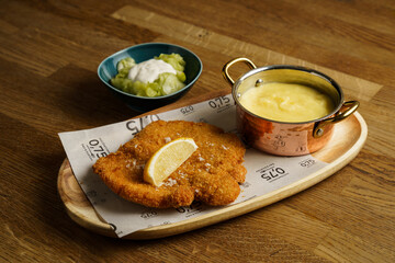 Traditional schnitzel with potato puree and cucumber salad