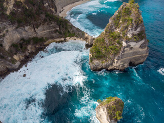 Breathtaking aerial view of a rocky coastline with crashing waves.